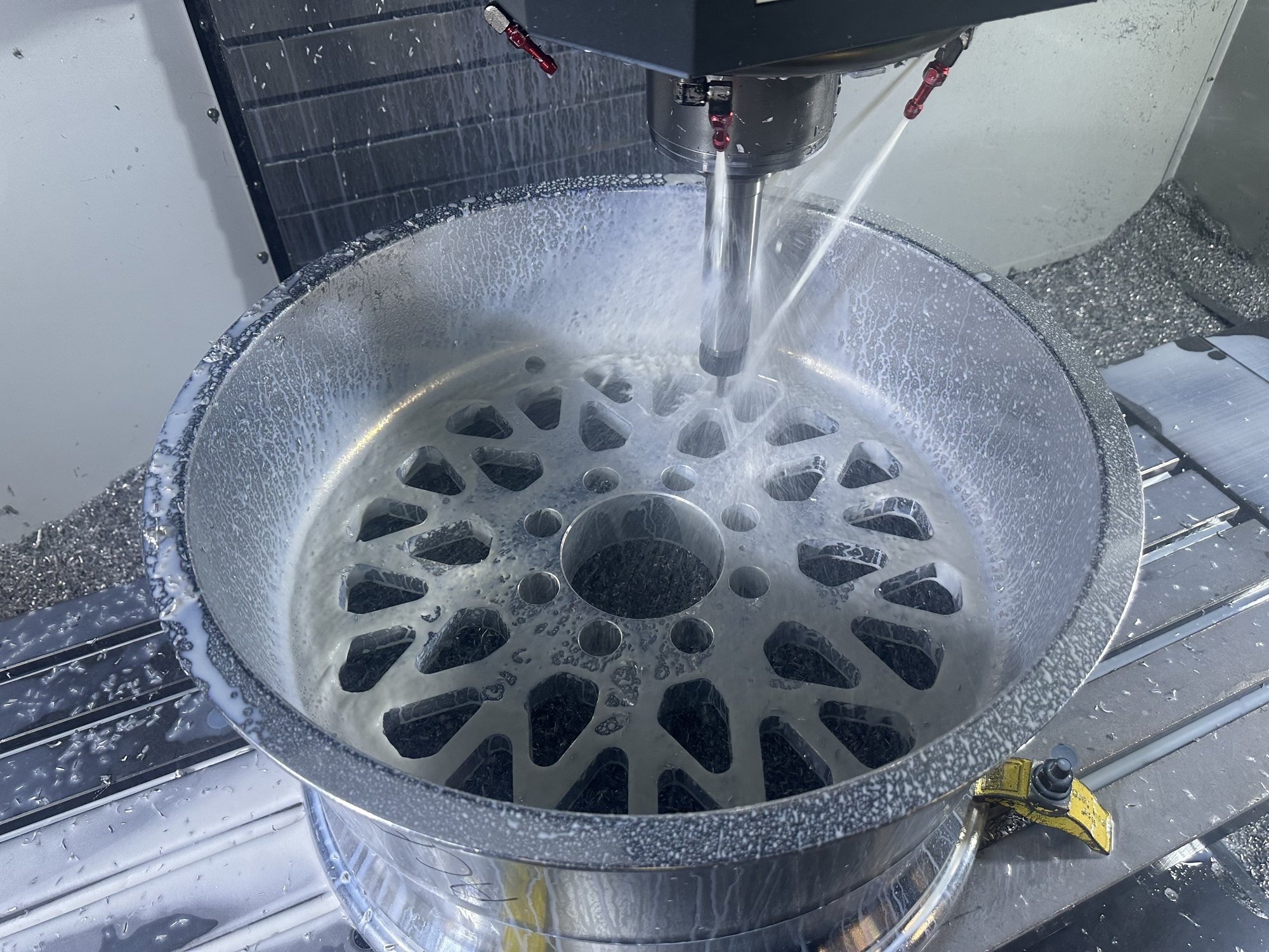 Ace Forged Vector wheel face being CNC cut with coolant