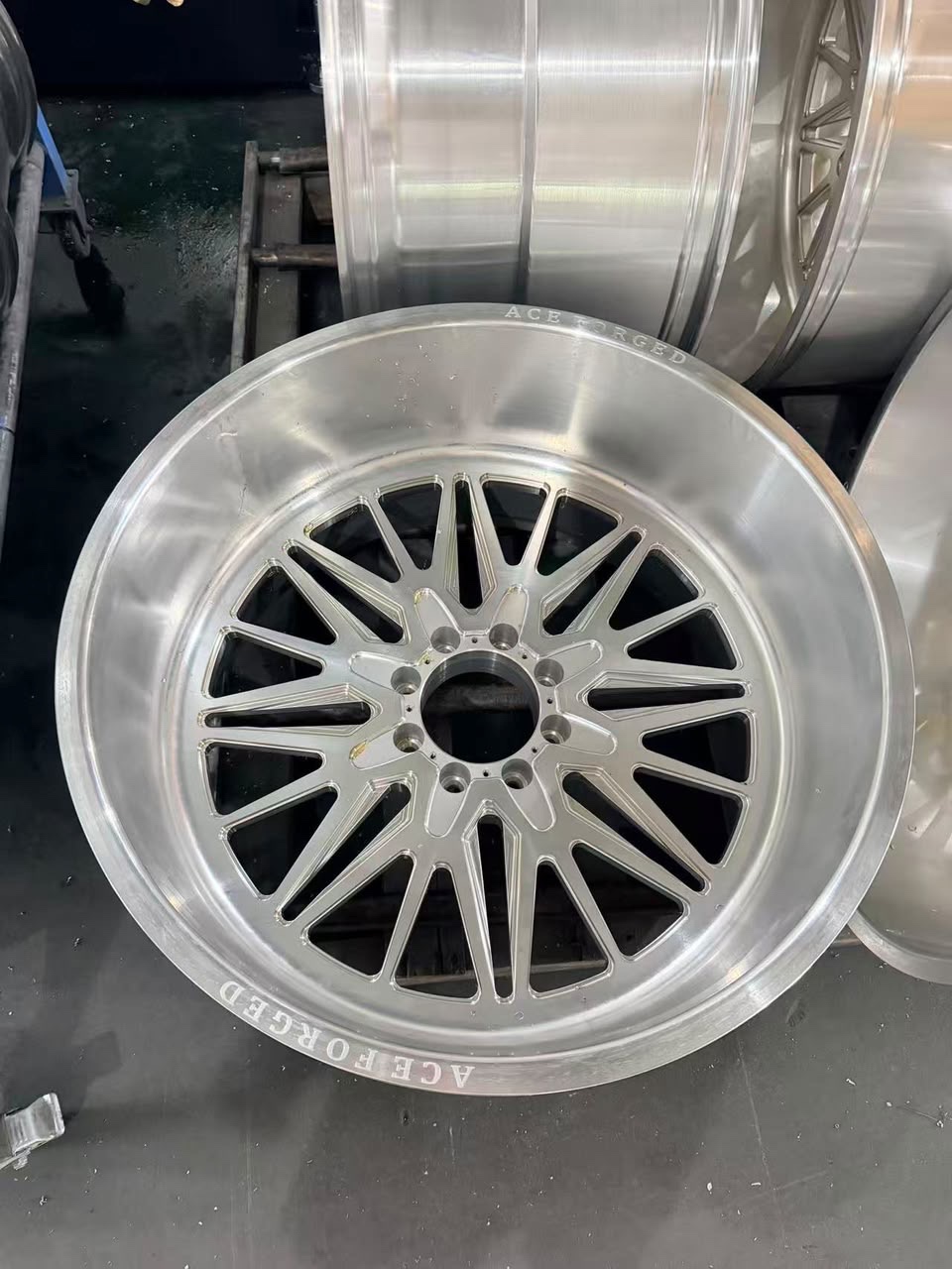 Finished Ace Forged multispoke wheel on the shop floor, ACE FORGED engraving on the lip