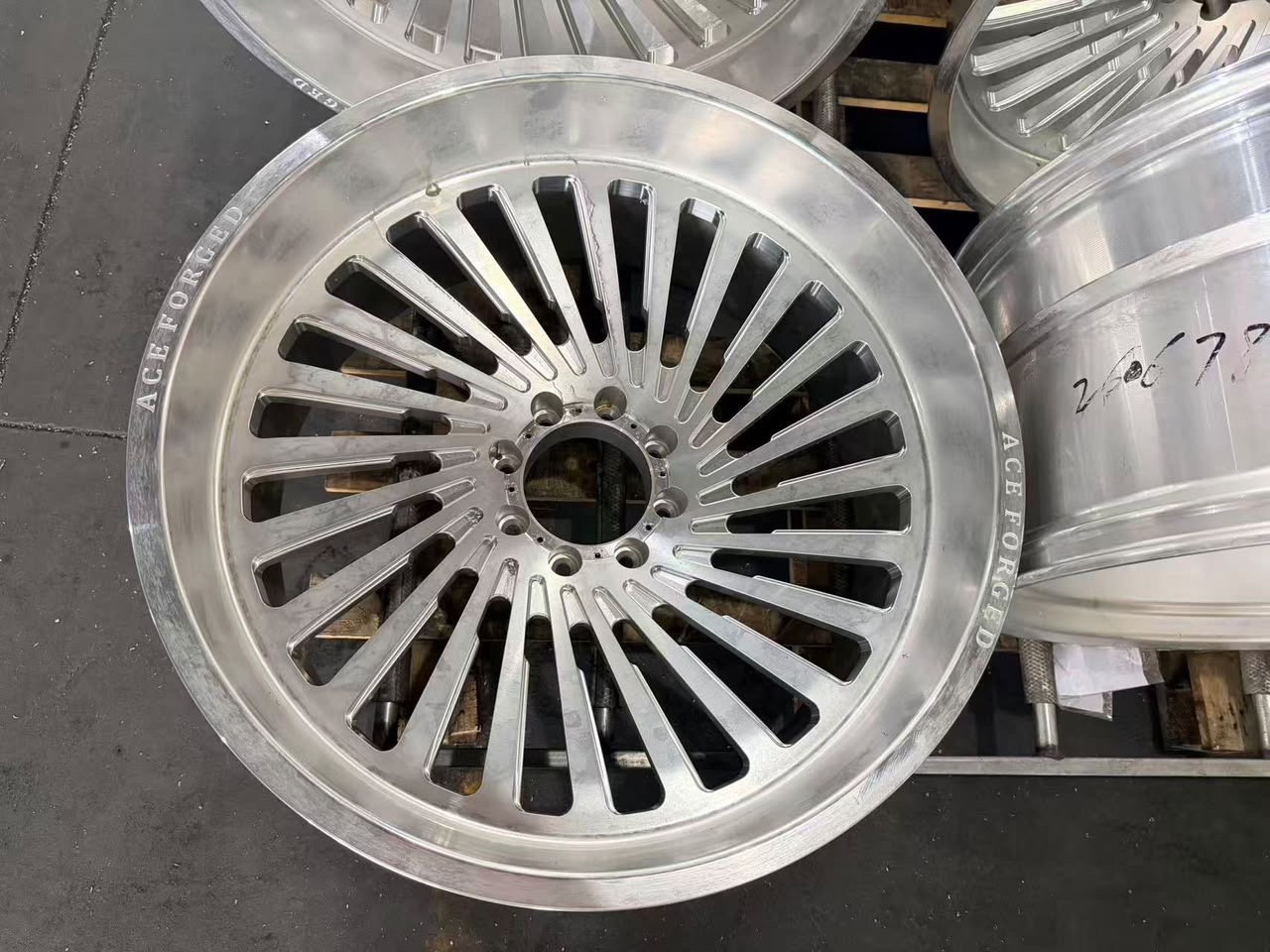 Ace Forged multispoke face fresh off the CNC, ACE FORGED lip engraving visible, pre-polish