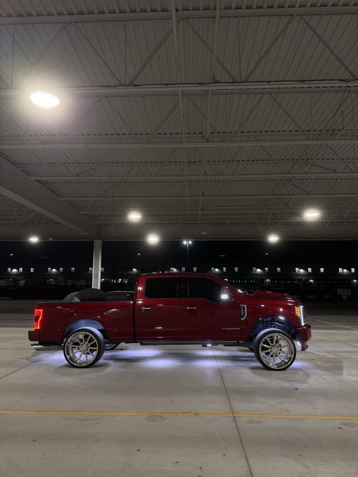 Candy red F-250 on Ace Forged Jackal wheels with underglow