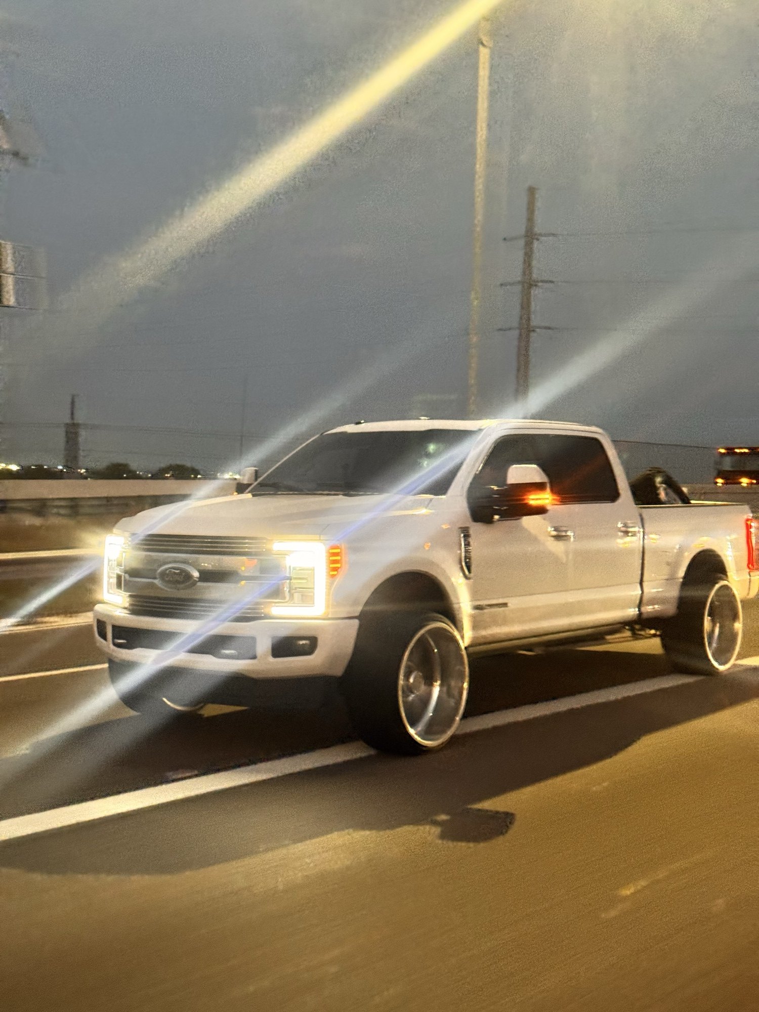 White F-250 on Ace Forged Vector rolling Texas freeway